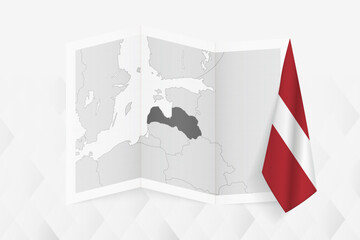 A grayscale map of Latvia with a hanging Latvian flag on one side. Vector map for many types of news.