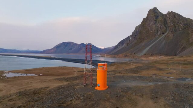 Arc Shot Of Hvalnes Lighthouse With Eystrahorn Mountain