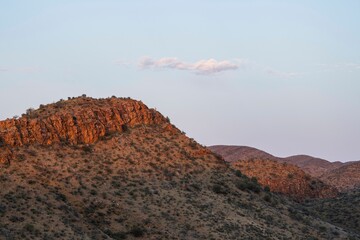 Landscape of mountains and trees udner the cloudy sky.
