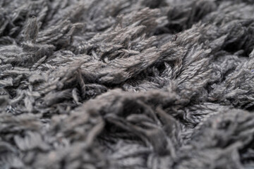 Texture of gray wool, macro cotton wool, gray natural sheep wool, texture, dark carpet, close-up, gray fleece,