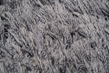 Texture of gray wool, macro cotton wool, gray natural sheep wool, texture, dark carpet, close-up, gray fleece,