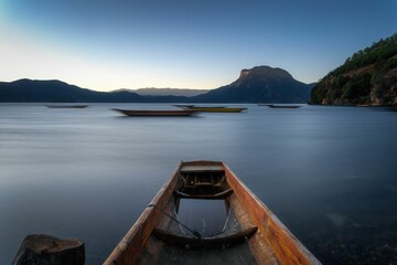 Long exposure shot of wooden rowing boats floating on the beautiful blue lake