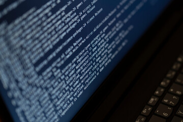 Working hours programming. The programmer prints new lines of HTML code. Notebook blueprint. Work time.