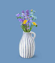 Stylish ceramic vase with bouquet of wildflowers on blue