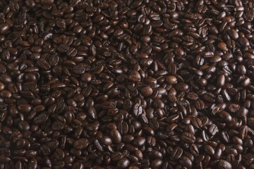 Closeup shot of a huge pile of dark coffee beans