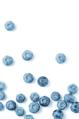 Fresh blueberries scattered on a white background.