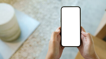 Fototapeta na wymiar Hand holding empty white screen smart phone on white background.
