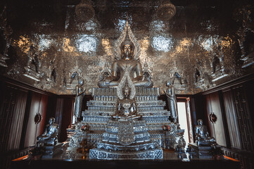 Chonburi, March 12, 2023. Wat Phon Prapa Nimit, This striking white Buddhist temple in a tranquil setting features a silver and mirrored interior. Interior of the church