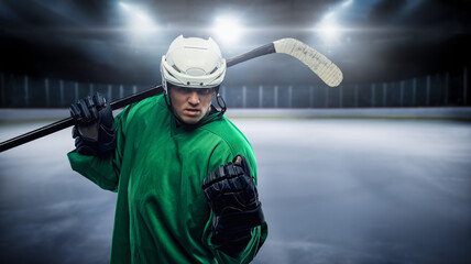 Naklejka premium Portrait of bold hockey player with hockey stick and uniform against rink.