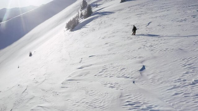 FPV aerial drone follow cam of male snowboarder dream powder open fresh snow run epic Vail Pass Colorado