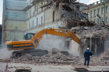 Demolition of building. Excavator breaks old house. Freeing up space for construction of new...