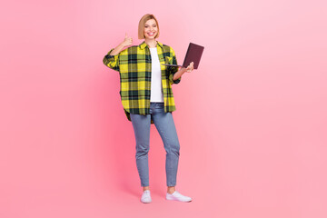 Full body photo of lovely young lady show thumb up hold gadget dressed stylish checkered yellow...