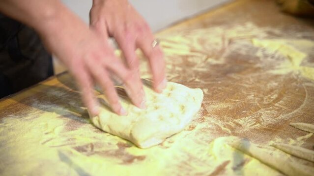 Close-up view of Woman hands kneading dough