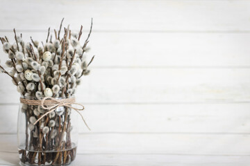Easter postcard. bouquet of a small willow in a glass vase tied with twine, greeting card