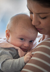 Newborn baby in mother's arms at home