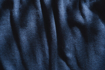 Abstract structure- wrinkles on the fabric. Textile-  simple dark background