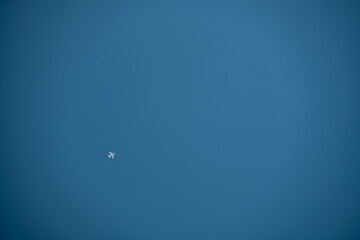 Obraz na płótnie Canvas Bright Blue Sky with Jet Airliner In Bottom Left Corner