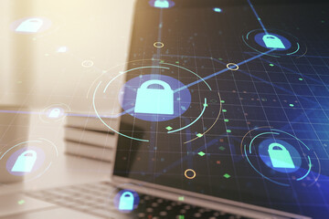 Double exposure of creative lock hologram with chip on laptop background. Information security concept
