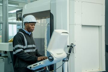 Fototapeta premium Engineer operating CNC computer machine working in industry factory.