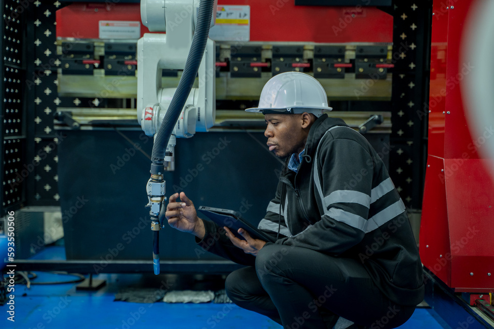 Aufkleber Engineers solve problems control panel of robot for setting programming for industrial robot arm controller in production plant factory.