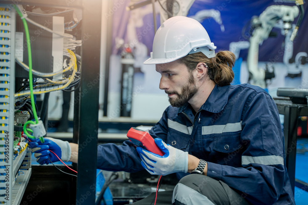 Leinwandbilder Technical engineer using measuring equipment to checking electrical current voltage at circuit breaker and cable wiring system for maintenance in main power distribution board.
