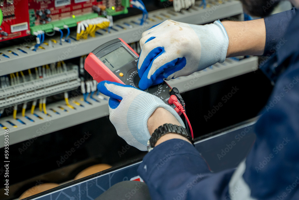 Aufkleber Electrical engineers using measuring them with a multimeter test electrical installations and wiring on protective relays.