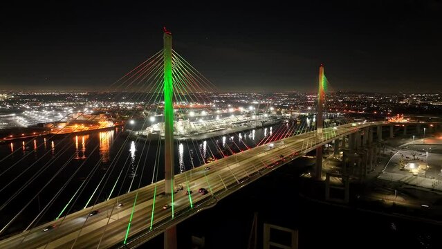 Gerald Desmond Bridge in Long Beach, CA aerial at night with city lights over port