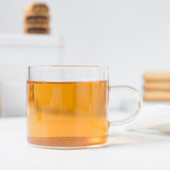 Tea in a glass cup, freshly brewed black tea in a trendy glass cup