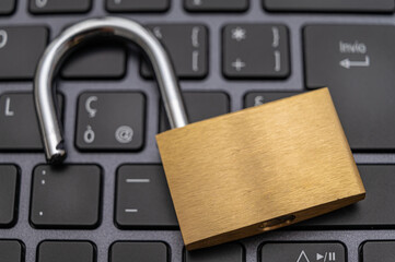 Open padlock, placed above a pc keyboard. Protection of personal and sensitive data, risk of intrusion. Privacy.
