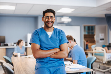 Nursing student smiling at the camera in a training ward