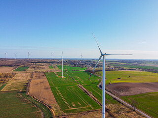 Aerial view of a wind farm in Poland. Renewable sources of electricity. Windmills in the fields....