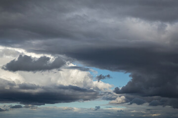 Fototapeta na wymiar Storm cloudy dramatic sky with dark rain grey cumulus cloud and blue sky background texture, thunderstorm, heaven
