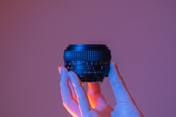 hand holding a camera lens