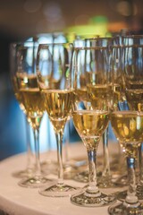 Vertical closeup of champagne glasses on a small table