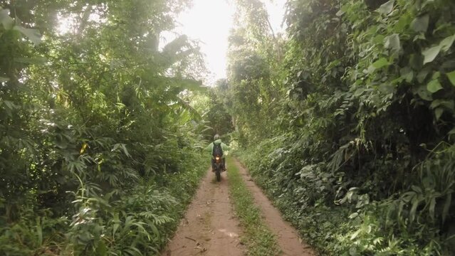 POV Rider Driving Enduro Dirt Motorbike on Gravel Trail in Tropical Rainforest Jungle, High Quality 4K Slow Motion Wide Angle Shot Extreme Action Motocross Sport Concept Footage, Thailand.
