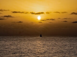 Ship Sailing into Sunset in Atlantic