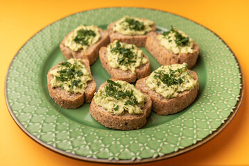 sandwich with fresh avocado in plate