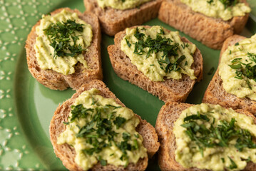 sandwich with fresh avocado in plate