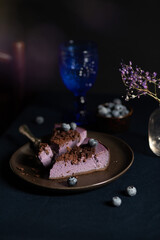 Obraz na płótnie Canvas Blueberry cheesecake with chocolate chips. Low key, vertical frame