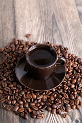 photo lots of roasted coffee beans and a cup of coffee
