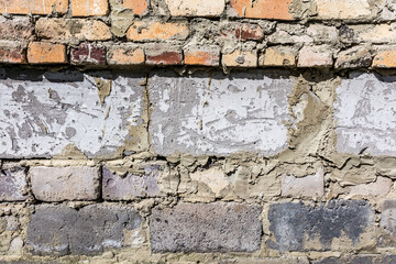 Masonry walls of red clay bricks and cinder blocks