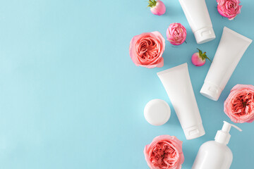 Top view photo of white cosmetic tubes without label pump bottle cream jars pink natural pink rose...