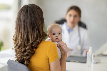 Mother with little baby visiting pediatrician in clinic