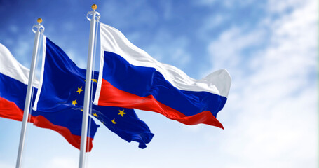 Russia and the European Union flags waving on a clear day