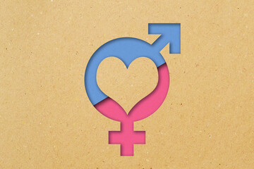 Female and male gender symbol with heart on recycled paper background - Concept of love and gender issues