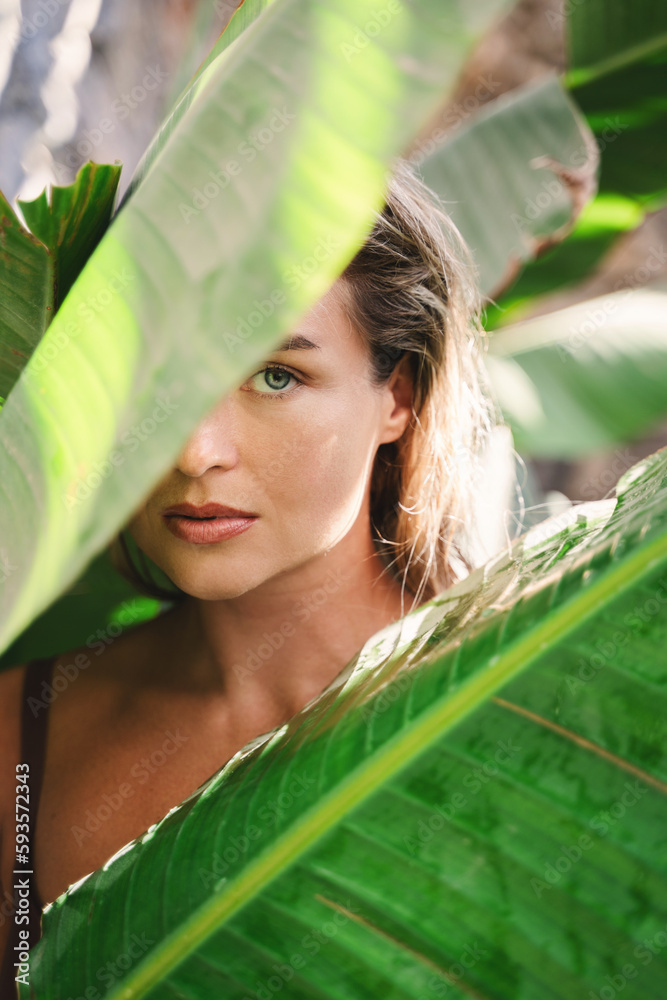 Sticker beautiful and natural looking woman with tropical banana leaves