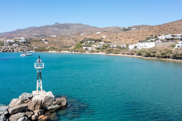 Greece Tinos island Agios Romanos village Cyclades. Aerial drone view of moored yacht beacon on rock