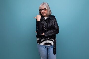 informal fresh healthy gray-haired middle-aged woman grandmother in a rocker jacket on a bright...