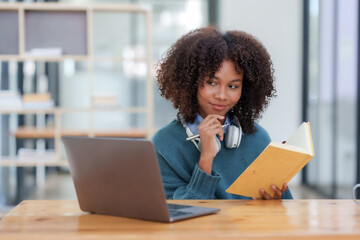 Happy young woman student having video call on laptop computer.