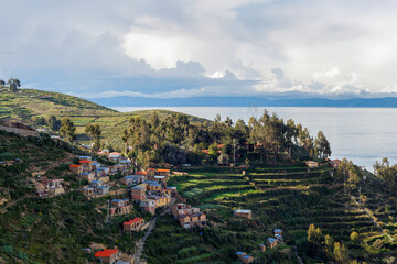 Obraz premium Village and terrace gardens on a hill, on the shore of the Lake Titicaca, Isla del Sol (Island of the Sun), Copacabana, Bolivia.